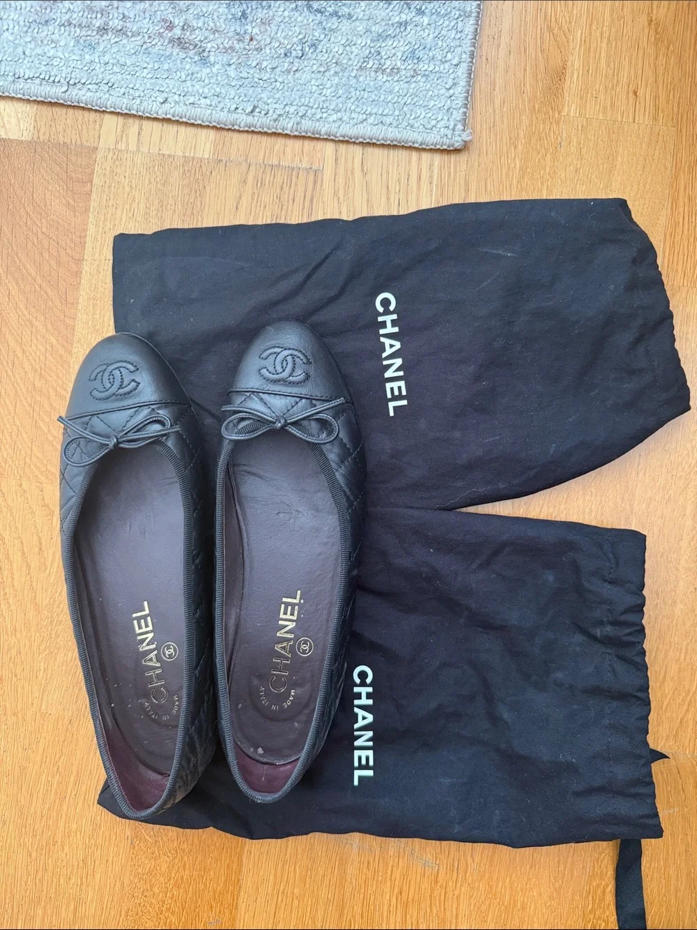 CHANEL Black Quilted Leather Ballet Flats with CC Logo and Bow